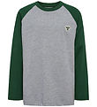 Hummel Pusero - hmlJR - Tummanvihreä M. Logo